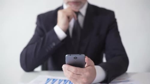 Expert Rubbing Chin, Reading Mobile App News Feed About Foreign Exchange Market
