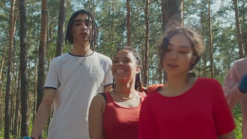 Young Adults Stand Together with Tools in Forest