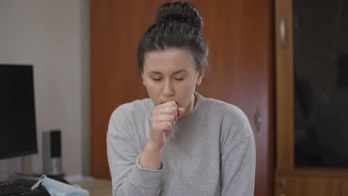 Portrait of Ill Woman Coughing Touching Chest Shaking Head Looking at Camera