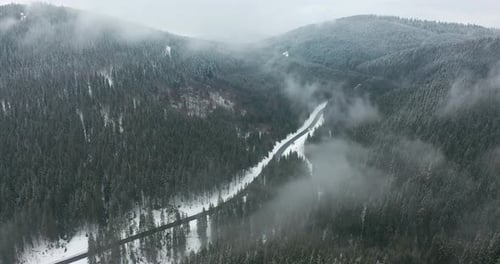 Aerial View. Scenic Mountain Landscape on a Winter Day, Fog in the Low Areas.