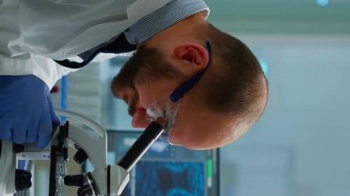 Scientist Works with Microscope in Modern Laboratory