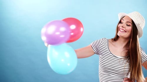 Cheerful Woman with Balloons Smiling in Studio