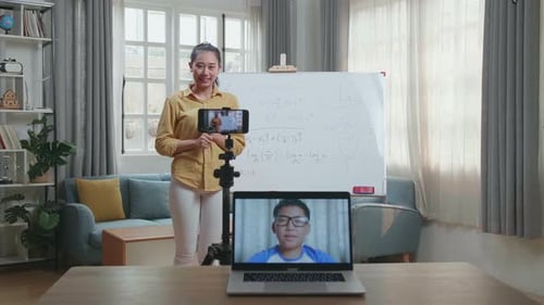 Young Woman Teaching Online Math Class at Home
