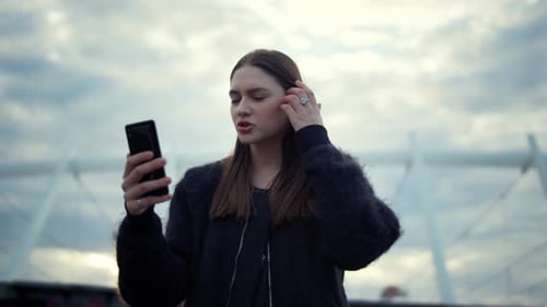 Young Woman Using Cell Phone in Urban Setting