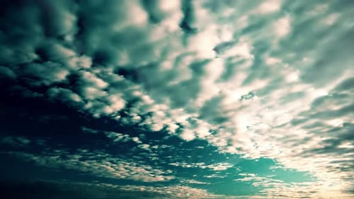 Teal Sky with Clouds and Golden Sunlight