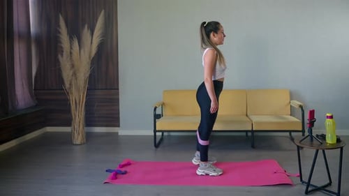Woman Exercising with Resistance Band at Home