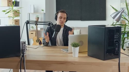Man Speaking Into Microphone at Home