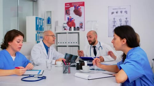 Medical Professionals Analyzing X-Ray in Hospital Conference Room