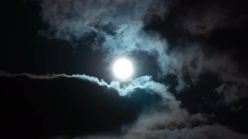 Moon Glimpsed through Moving Clouds at Night