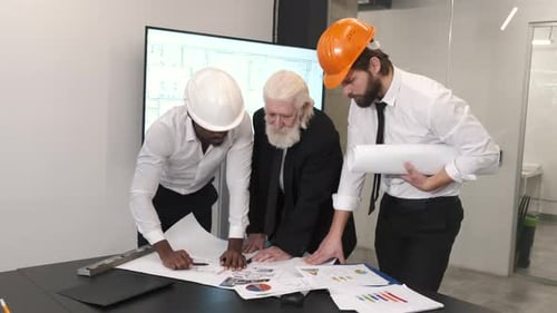 Construction Engineers Teamwork Analyzing Building Design