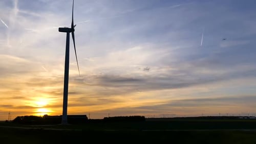 Wind Turbines in a Rural Field at Sunset