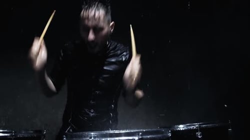 Passionate Drummer Performing in the Rain