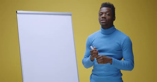 Jeune homme enseignant une langue avec Flipchart