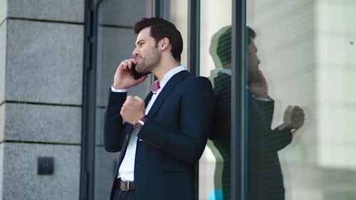 Man in Suit Talking on Phone Outdoors