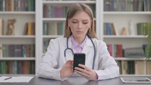 Lady Doctor Using Smartphone in Clinic