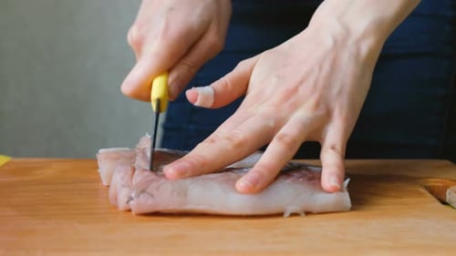 Cutting Fresh Raw Fish Fillet into Pieces