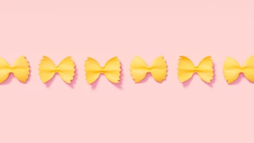 Seamless Loop of Farfalle Pasta on Pink Background