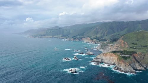 Inspiring View of the Mountainous Ocean Coastline Under the Overcast Sky. Aerial Footage.
