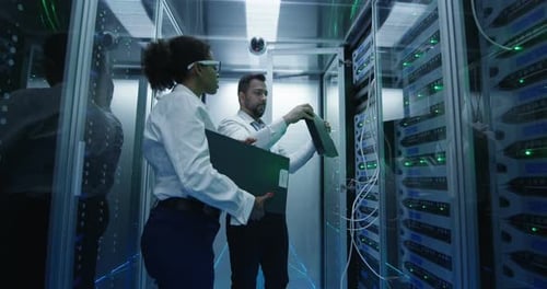 Two Employees Performing Maintenance in a Data Center