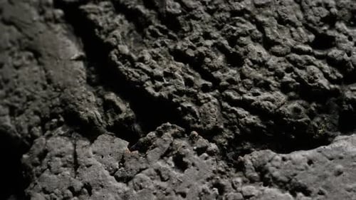 Textured Gray Surface with Dramatic Shadows and Highlights