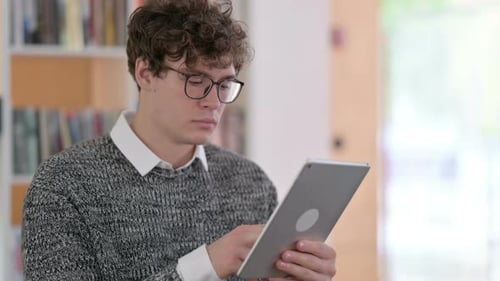 Young Adult Using Tablet Indoors