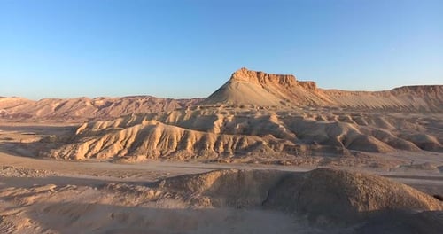 Aerial footage at the desert viewing a beautiful mountain during sunrise