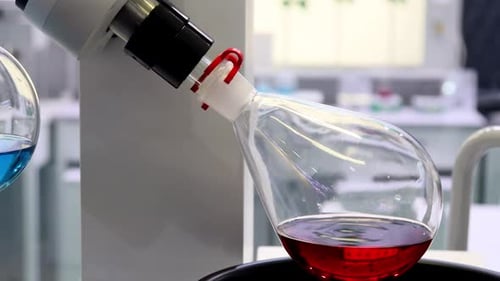 Red Solution Mixing in Laboratory Flask