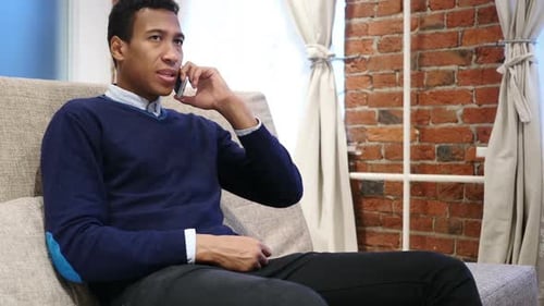 Young Adult Using Smartphone and Talking on Phone