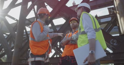 Construction Workers Discussing Project with Laptop