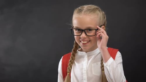 Playful Schoolgirl in Eyeglasses Winking on Camera, Love to School, Education