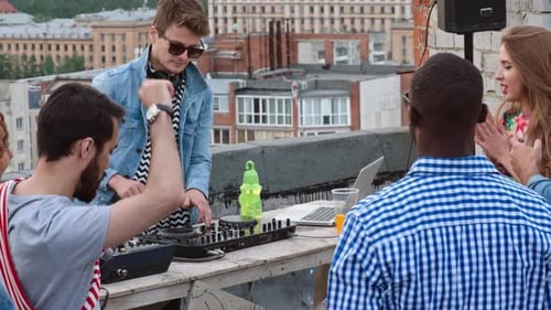 Young Adults at Rooftop Party With a DJ