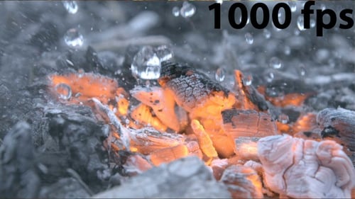 Putting Out A Fire Macro Shot Of Burning Coals With Water Drops And Smoke Extinguishing Flame