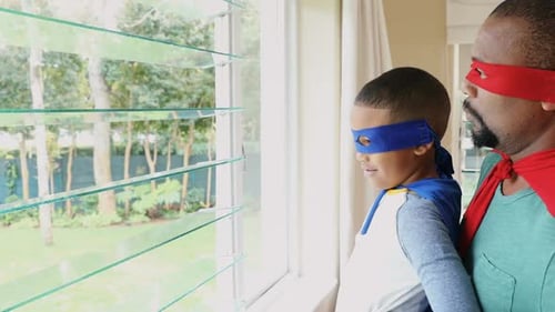 Dad and Son Play Superhero Together Indoors