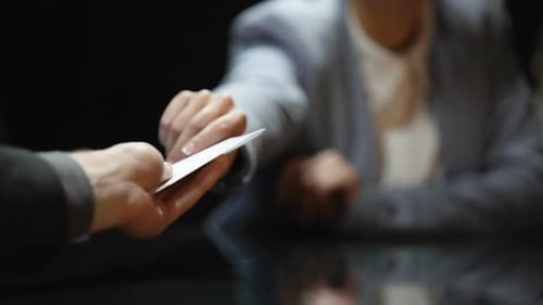 Woman Handing Torn Paper for Money at Table