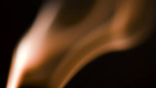 Abstract Light Orange Smoke on Black Background