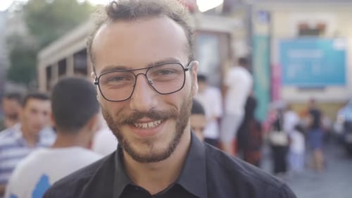 Portrait of Bearded Man with Glasses on City Street