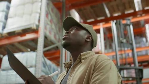 African American Warehouse Worker Doing Inventory