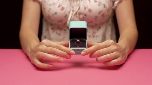 Ring Revealed in Jewelry Box on Pink Table