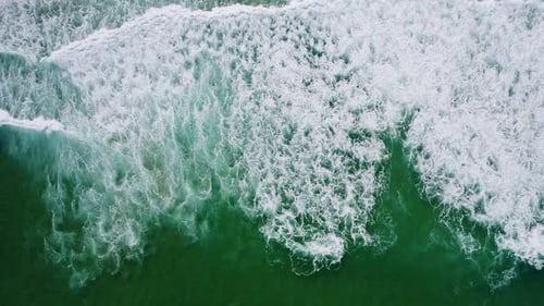 Aerial Top Down Footage of White Waves and Emerald Green Ocean Water Surface
