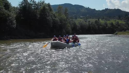 People Kayaking on River on Mountain Nature Background