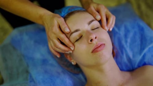 Woman Receives Relaxing Facial Massage at Spa