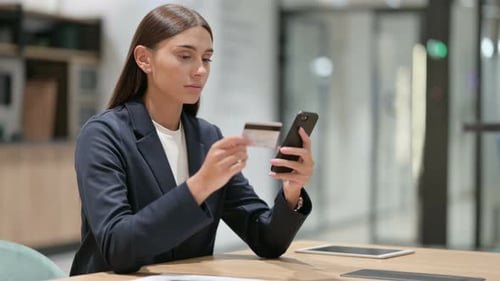 Brunette Woman Uses Credit Card and Mobile Phone