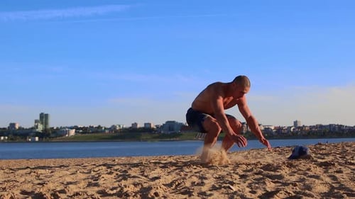 Young Fit Man Doing Push Ups on the Beach Sand and Performing Somersaults