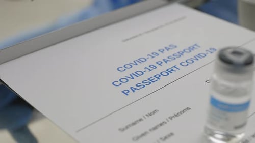 Crop View of Medical Worker Hand Putting Stamp on Carton COVID19 Vaccine Immunization Card