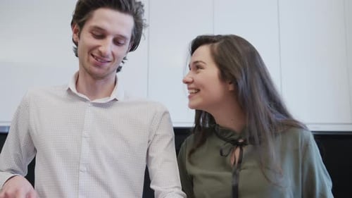 Happy Couple Smiling and Kissing in Modern Kitchen