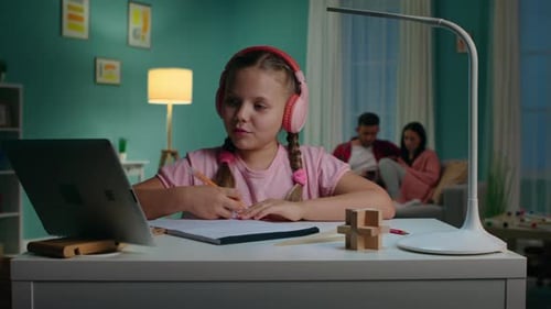 Girl Doing Homework at Desk with Laptop