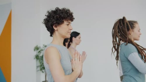 Group in Yoga Class Practicing Balance Pose