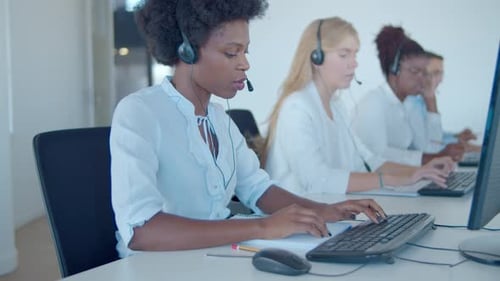 Team Call Center Operators Headsets Sitting Row
