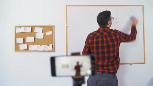 Teacher Giving Online Math Lesson at Whiteboard