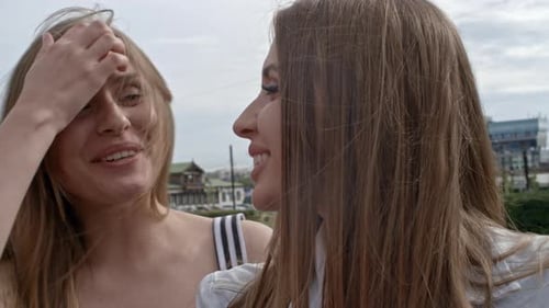 Women Smiling and Chatting Outdoors